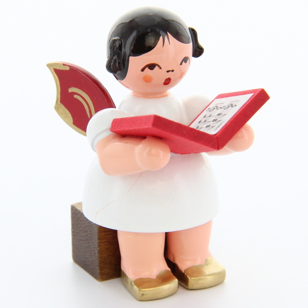 Engel sitzend mit Buch, rote Flügel